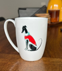 White mug with a dog illustration on a wooden table