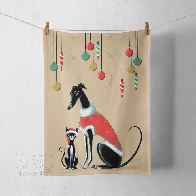 Tea towel with a greyhound or whippet and cat illustration wearing Christmas outfits.