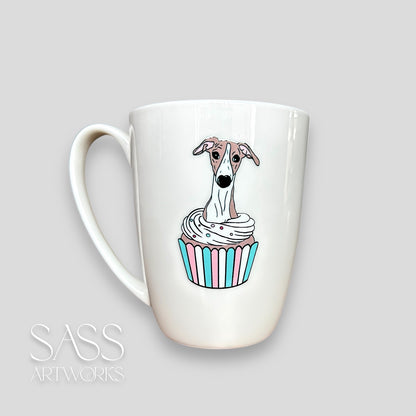 White mug with a whippet  in a cupcake design on a light grey background, featuring the brand 'SASS Artworks'.