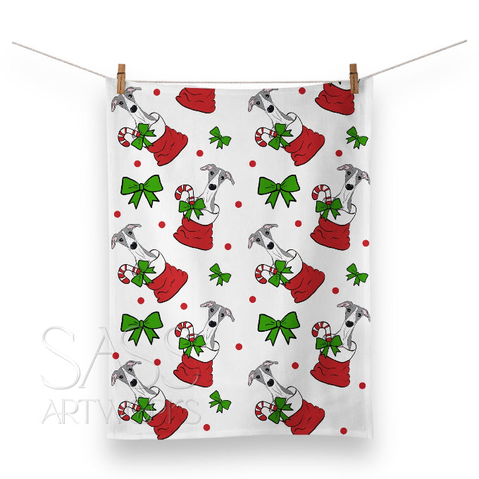 Christmas-themed towel with whippets or greyhounds in red sacks and candy canes 